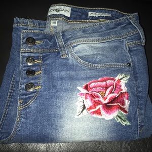 Ripped jeans with floral patches